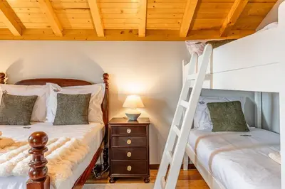 two bunk beds in a room with a ladder at Recanto do Pomar - Three bedroom villa in Ponta do Sol
