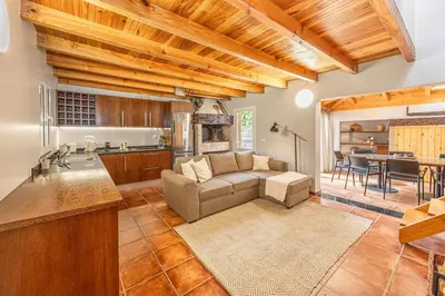 a kitchen and living room with a couch and a table at Recanto do Pomar - Three bedroom villa in Ponta do Sol