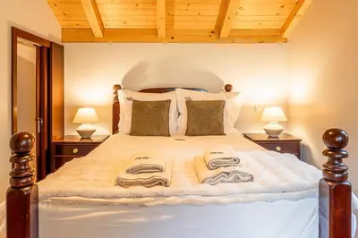 a bedroom with a large bed with towels on it at Recanto do Pomar - Three bedroom villa in Ponta do Sol