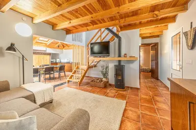 a living room with a couch and a television at Recanto do Pomar - Three bedroom villa in Ponta do Sol