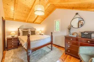 a bedroom with a bed and a wooden ceiling at Recanto do Pomar - Three bedroom villa in Ponta do Sol