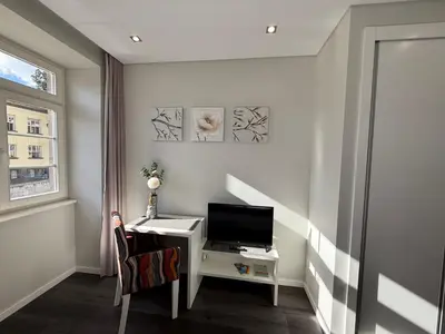 a room with a desk with a computer and a window at Gold Center Funchal 103 in Funchal