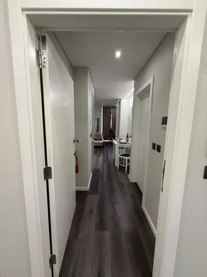 a hallway with white walls and wooden floors at Gold Center Funchal 103 in Funchal