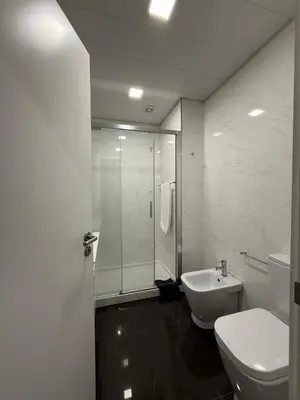 a bathroom with a shower and a toilet and a sink at Gold Center Funchal 103 in Funchal