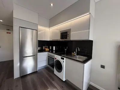 a kitchen with a stainless steel refrigerator and a dishwasher at Gold Center Funchal 103 in Funchal