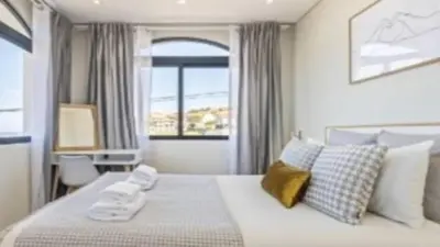 a bedroom with a large white bed and a window at Apartment superb in Funchal in Funchal