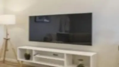 a living room with a large television on a wall at Apartment superb in Funchal in Funchal