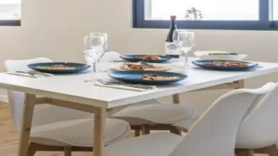 a white table with blue plates and wine glasses at Apartment superb in Funchal in Funchal