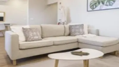 a living room with a white couch and a table at Apartment superb in Funchal in Funchal