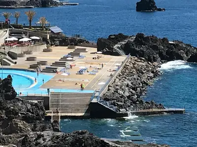 a resort with a swimming pool next to the ocean at Апартаменты 303 - Studio in Funchal
