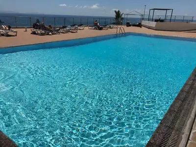 a large blue swimming pool on top of a building at Апартаменты 303 - Studio in Funchal