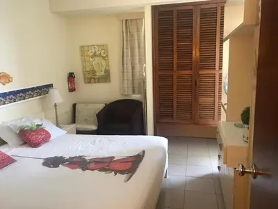 a bedroom with a bed and a chair in a room at Апартаменты 303 - Studio in Funchal