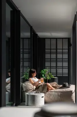 a woman sitting on a bed in a room at Savoy Insular V by An Island Apart in Funchal