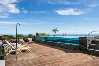 a swimming pool with a view of the ocean at Savoy Insular V by An Island Apart in Funchal