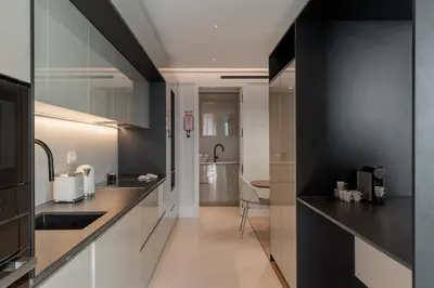 a kitchen with black and white walls and a counter at Savoy Insular V by An Island Apart in Funchal