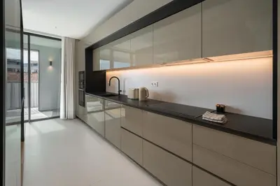 a kitchen with black and white cabinets and a sink at Savoy Insular V by An Island Apart in Funchal