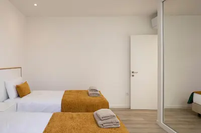 a bedroom with a bed and a mirror at Marco 4 Seasons- Spring in Arco da Calheta