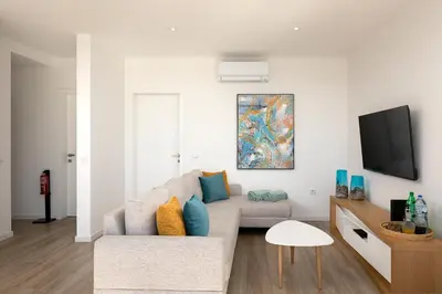 a living room with a couch and a tv at Marco 4 Seasons- Spring in Arco da Calheta