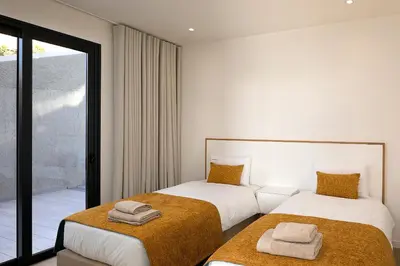 a bedroom with two beds with towels on them at Marco 4 Seasons- Spring in Arco da Calheta