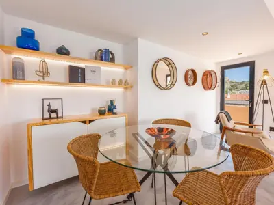 a dining room with a glass table and chairs at Baía Beach Apartment in Luz