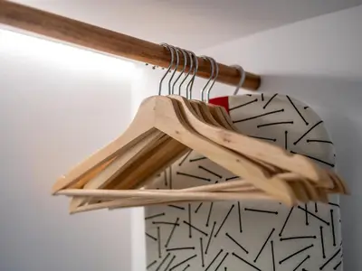 a wooden hanger with a white wall with at Apt. Rocha N. in Lagos