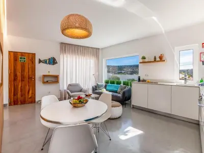 a kitchen and living room with a table and chairs at Apt. Rocha N. in Lagos