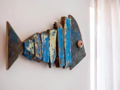 a bunch of rusted objects hanging on a wall at Apt. Rocha N. in Lagos