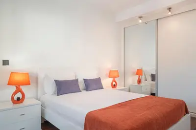 a bedroom with a white bed and two lamps at Madalenas II by An Island Apart in Funchal