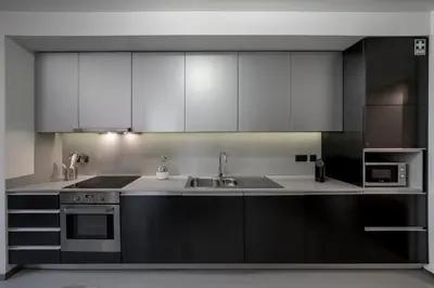 a kitchen with white cabinets and a sink at Madalenas II by An Island Apart in Funchal