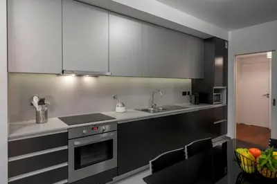 a kitchen with black and white cabinets and a sink at Madalenas II by An Island Apart in Funchal