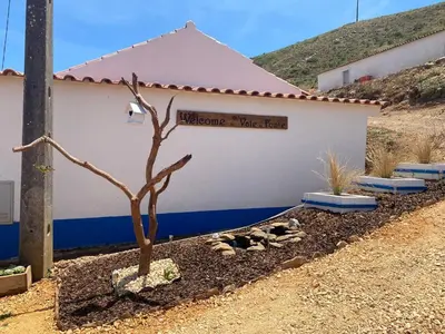 a building with a sign that reads welcome wife fund at Casa Rochinha in Aljezur