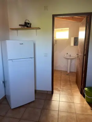 a kitchen with a white refrigerator and a sink at Casa Rochinha in Aljezur