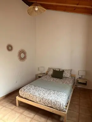 a bedroom with a bed and two night stands at Casa Rochinha in Aljezur