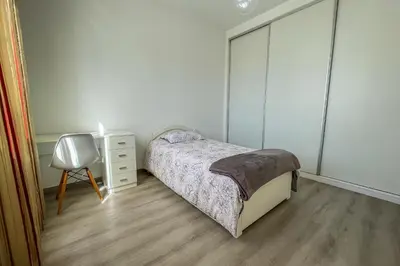 a bedroom with a bed and a table and a chair at Faria House by Horizon View Madeira in Funchal