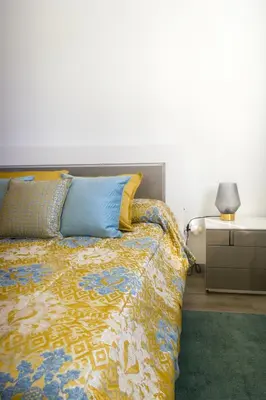 a bedroom with a bed and a night stand with a lamp at Faria House by Horizon View Madeira in Funchal