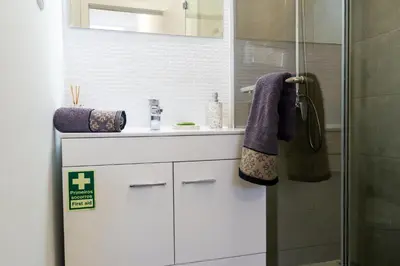 a bathroom with a white sink and a shower at Faria House by Horizon View Madeira in Funchal