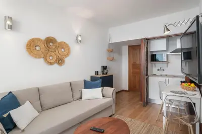 a living room with a couch and a kitchen at Incredible sea view Apartamento do Mar I in Funchal