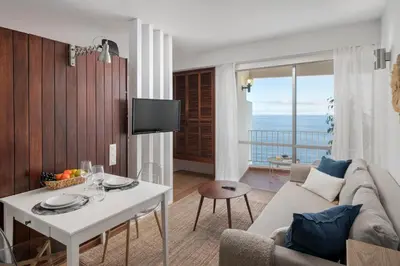 a living room with a couch and a table at Incredible sea view Apartamento do Mar I in Funchal
