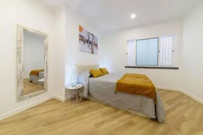 a white bedroom with a bed and a mirror at Debbie & Cris House by Mth in Machico