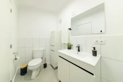 a white bathroom with a shower and a sink at Debbie & Cris House by Mth in Machico