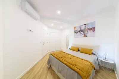 a white bedroom with a bed with yellow sheets at Debbie & Cris House by Mth in Machico