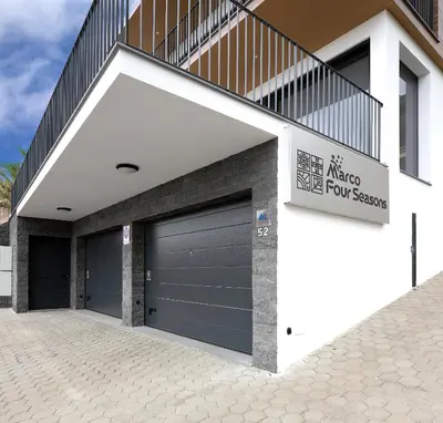 a garage with two garage doors on a building at Marco 4 Seasons- Summer in Arco da Calheta