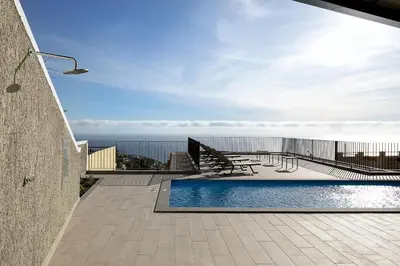 a swimming pool on the roof of a house at Marco 4 Seasons- Summer in Arco da Calheta