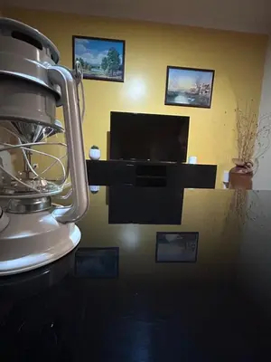 a living room with a flat screen tv and a tv stand at Vila Mendes - Ocean View in Arco da Calheta