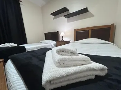 a room with two beds with towels on them at Vila Mendes - Ocean View in Arco da Calheta