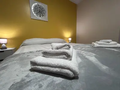 a bedroom with white towels on a bed at Vila Mendes - Ocean View in Arco da Calheta