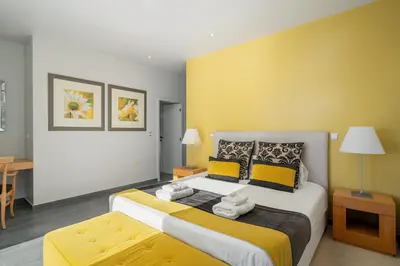 a living room with a couch and paintings on the wall at Villa Harmonia by Homie in Ponta do Sol