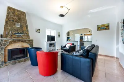 a living room with a couch and a fireplace at Casa Cool in Aljezur