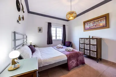 a bedroom with a bed with two towels on it at Casa Cool in Aljezur
