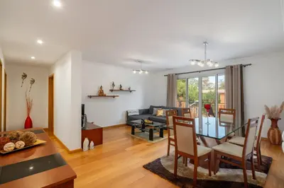 a living room with a table and a couch at Caniço Golden by An Island Apart in Caniço